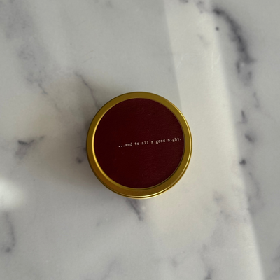 Candle jar lid with text on a marble surface